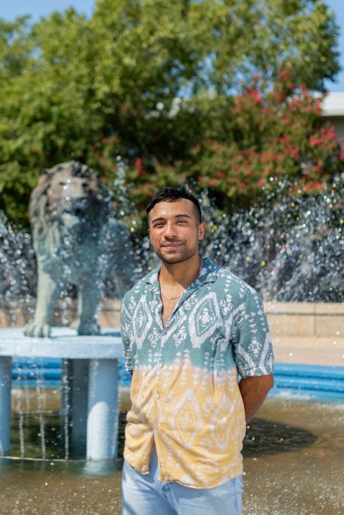 Irv Antonio in front of the lion fountain.
